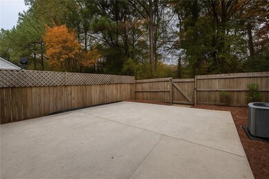 Fenced backyard with a patio area and a gate