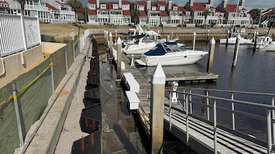 Dock area featuring a residential view and a water