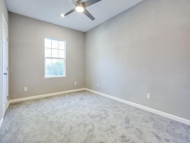 Unfurnished room with baseboards, a ceiling fan, a