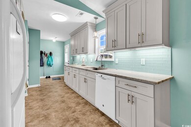 Kitchen featuring dishwasher, a sink, backsplash, 