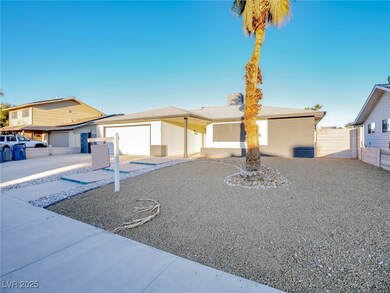 Ranch-style home featuring brick siding, driveway, and a garage