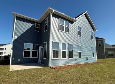 Back of property featuring a lawn and a patio