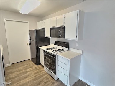 Kitchen featuring light countertops, black applian