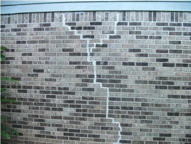 crack in the exterior wall of brick