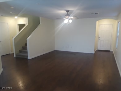 Unfurnished living room featuring dark wood-type f