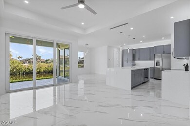Kitchen featuring gray cabinetry, light marble fin