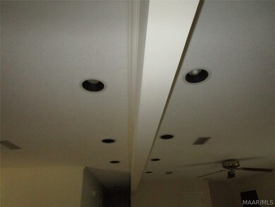 Recessed lighting on both sides of beam for formal