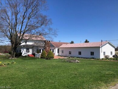 rear of home showing large garage & patio