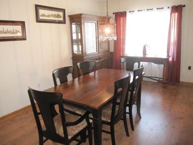 Dining room with window off the side of the house.