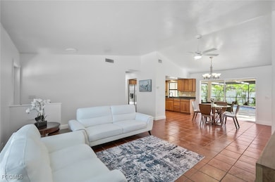 Great room toward kitchen and dining room with access to the lanai/pool area