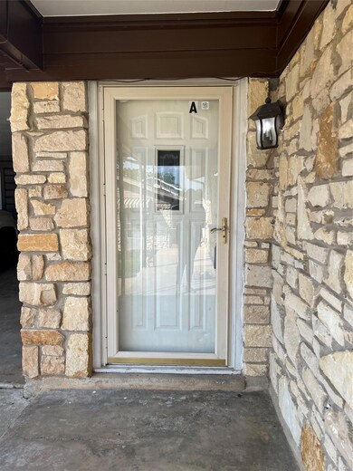 Property entrance featuring stone siding
