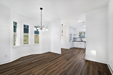 The dining area showcases a timeless black glass a