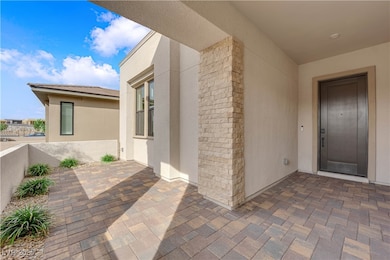 Property entrance featuring a patio and stucco sid