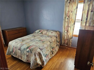 Bedroom featuring hardwood / wood-style floors and multiple windows