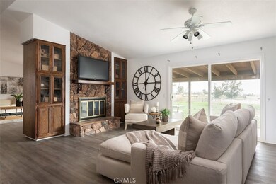 Living room with access to the back patio and backyard acreage