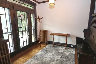 Impressive Foyer with Hardwood Floors & Leaded Gla