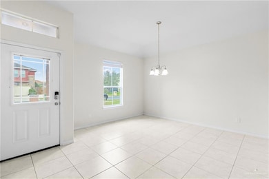 Tiled entrance foyer featuring an inviting chandelier