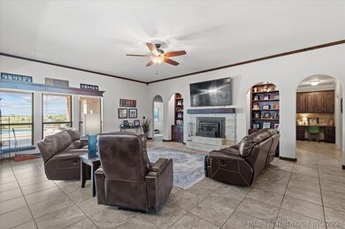 Spacious living room features a stone fireplace, i