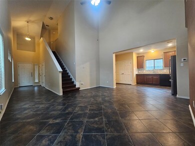 Unfurnished living room featuring a high ceiling 