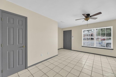 Tiled spare room with ceiling fan