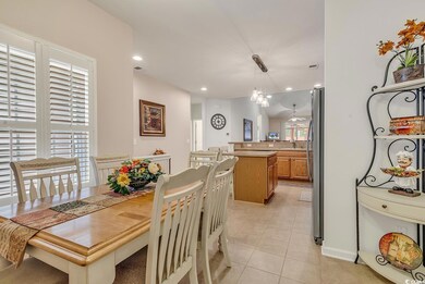 Tiled dining room with sink and a chandelier