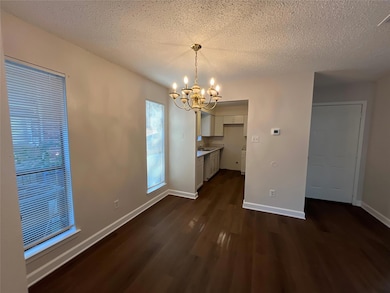 Unfurnished dining area featuring a chandelier, a