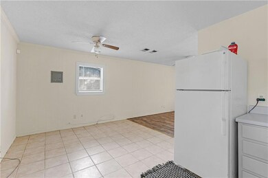 Kitchen with a textured ceiling, visible vents, fr