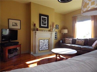 Living room features one of two decorative firepla