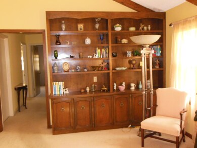 The built bookcase and fireplace are all in the den