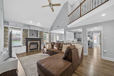 Living room has vaulted ceilings and a ton of natural light.