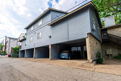 View of side of property featuring a carport and 