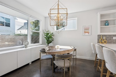 Dining room with radiator, finished concrete floors, and a chandelier