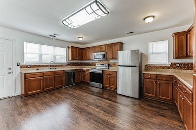 Kitchen featuring sink, dark wood-type flooring, a