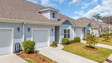 View of front of property with a front yard, an at