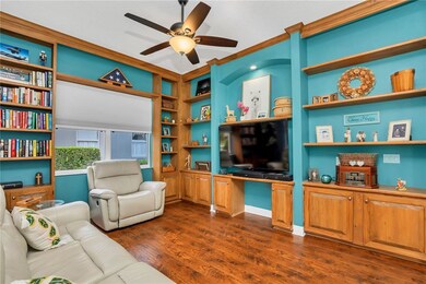 LIVING ROOM WITH GREAT PULL DOWN BLINDS.