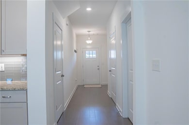 Doorway to outside featuring baseboards