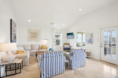 Looking towards the living room space from the open kitchen and dining area. Did you notice all the windows? Sit back on your comfortable couch, and take in the views of the beach!