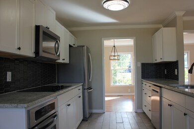 New Everything!  Kitchen w/Tile Floors & Backsplash; Granite Counters & All New Appliances!  (Looking towards the Dining Area)