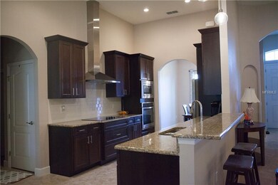 Gourmet kitchen with solid surface counters and wo