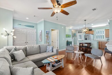 Living area with crown molding, visible vents, hardwood / wood-style floors, and recessed lighting