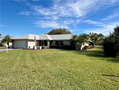 Ranch-style home with a front lawn and a garage