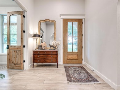 Entrance foyer with baseboards and light wood-type flooring