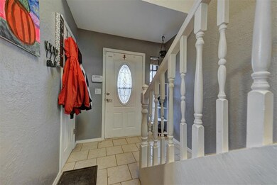 Entrance foyer with light tile patterned flooring