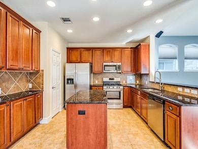 Kitchen featuring a center island, visible vents,