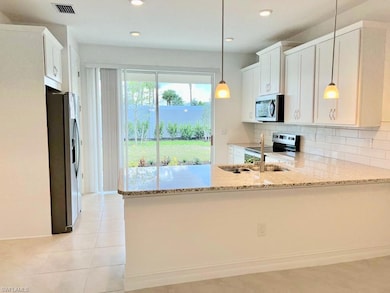Kitchen with stainless steel appliances, visible v