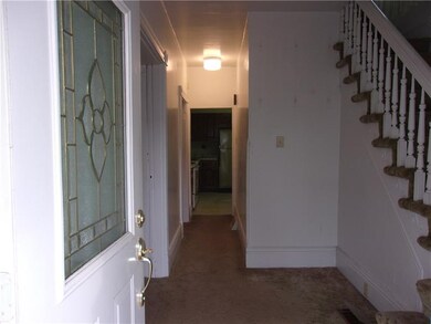 Sunlit entry leads to living and dining rooms on l