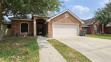 Single story home featuring a garage and a front lawn