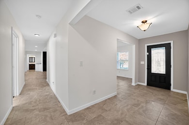 Foyer entrance featuring baseboards