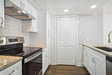 Kitchen featuring dark wood finished floors, a sin