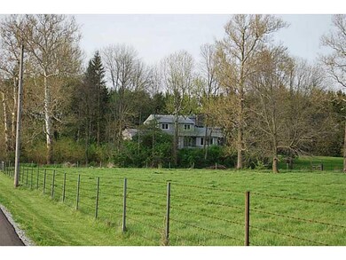 Exterior Front. View from the road shows how this beauty is nestled onto the hilltop.